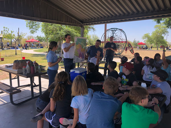 Volunteers teaching kids at the fourth-grade water festival about our watershed.